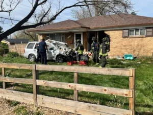 Driver crashes into Aurora home, injuring woman, before fleeing scene