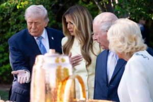 Trump holds bee while showing King Charles honey made at White House