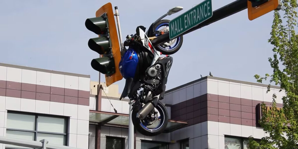 VIDEO: Motorcycle ends up hanging off traffic light after wild crash in Vancouver, Canada