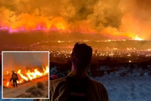 Two massive wildfires converge to rip across California and Nevada as homes razed and evacuations ordered